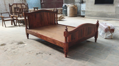 Sheesham wooden bed frame with paneled headboard and footboard in workshop