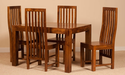 A 5-piece wooden dining set consisting of a rectangular table and four matching high-back chairs with vertical slat backs, shown against a plain beige wall and carpet.