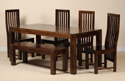 A 5-piece dark brown wooden dining set including a rectangular table, a bench, and four matching slatted chairs, shown against a neutral beige wall and carpet.