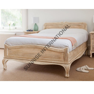 French style solid wood bed with curved headboard and footboard in bedroom setting
