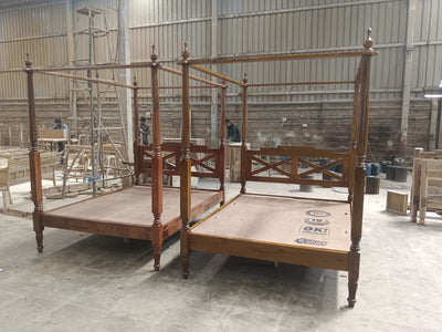 Mango wood four poster beds with hand-carved posts shown during workshop production