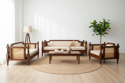 A 4-piece wooden living room furniture set with woven cane panels, including a sofa, two armchairs, and a coffee table, arranged on a round jute rug in a bright, modern room.