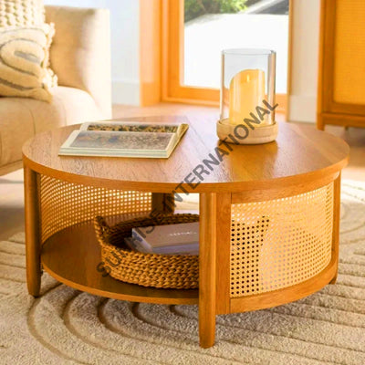 Round solid wood centre table with rattan cane work and lower shelf in living room