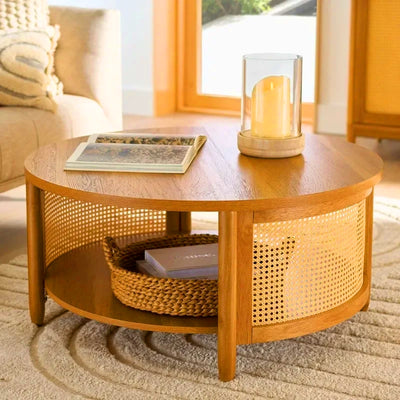Round solid wood coffee table with rattan cane panels and bottom shelf