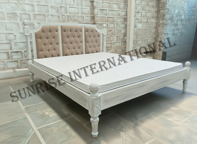 Mango wooden bed with tufted upholstered headboard shown with mattress