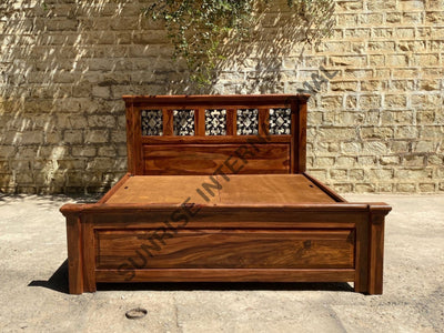 Sheesham wooden bed with artistic jali headboard and paneled footboard, front view