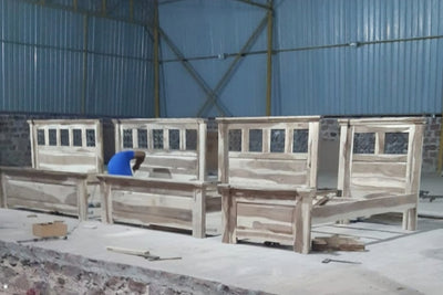 Sheesham wood jali bed frames shown during workshop finishing and production