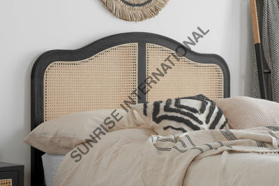 Artistic rattan cane headboard on solid Sheesham wood bed, close-up
