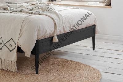 Sheesham wooden bed showing slim footboard and raised wooden legs