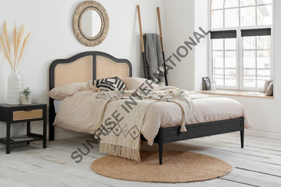 Rattan cane wooden bed with Sheesham wood frame in bedroom setting