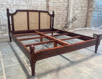 Sheesham wooden bed showing mattress support frame and rattan cane headboard
