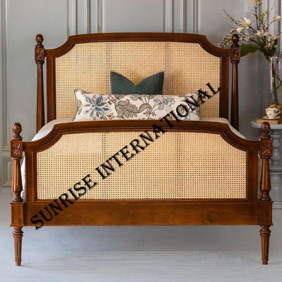 Mid-century Sheesham wood bed with rattan cane headboard and footboard in bedroom setting