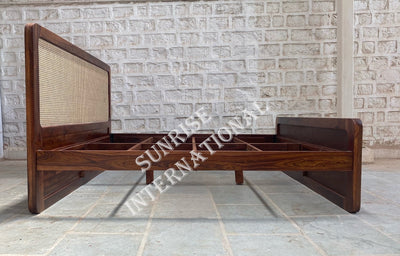 Sheesham wood bed with rattan cane headboard and footboard, side view