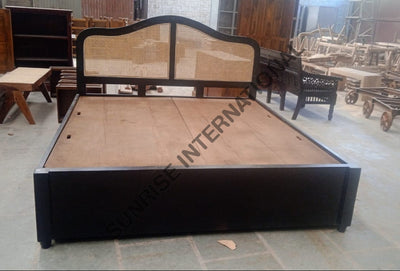 Solid wooden bed with rattan cane headboard and storage drawers, front view