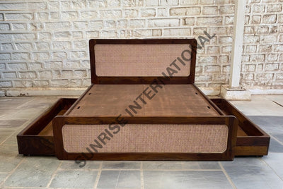 Sheesham wooden bed showing two open side storage drawers and rattan cane panels