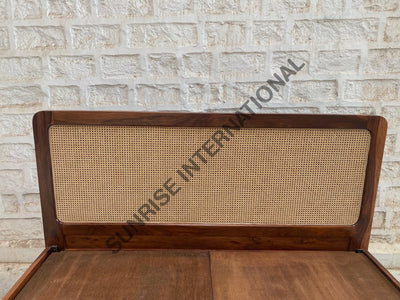 Rattan cane headboard on solid Sheesham wood bed, close-up view