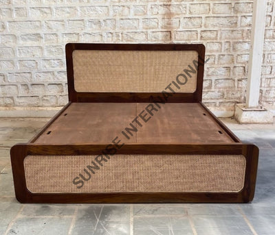 Solid wooden bed with rattan cane headboard and footboard, front view