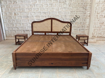 Wooden bed with rattan cane headboard and box storage, front view
