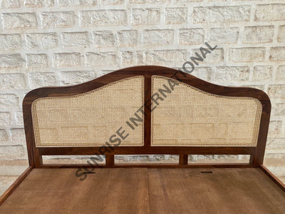 Rattan cane headboard on solid Sheesham wood bed, close-up view
