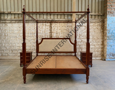 Front view of upholstered four poster bed with fabric headboard
