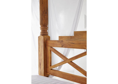 Wooden poster bed showing carved post and geometric Mango wood headboard detail