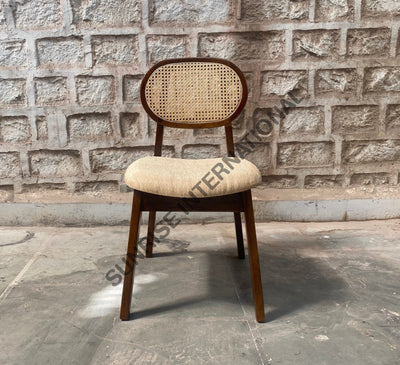 Front view of Mango wood rattan dining chair with cushioned seat