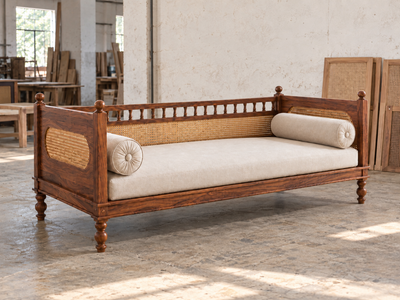 Rattan cane wooden daybed diwan in Sheesham wood shown from an angled view