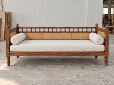 Sheesham wood daybed diwan with rattan cane front view and off-white bolsters