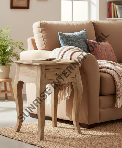 Wooden end table with drawer beside a living room sofa