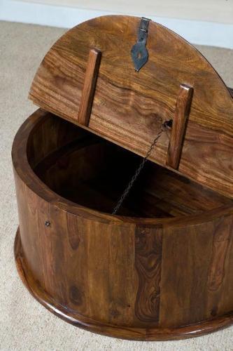 Round wooden coffee table with hinged lid open to show internal storage